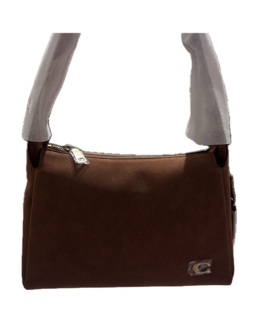 Coach Brown Suede Shoulder Bag (Category: Luxury Bags & Wallets) located in Manaoag. Submitted by ianka10 (Listing ID 1467306981, Image 2). Description: NEW ARRIVAL!! (Sourced from JPN and KOR) - Elegant gold-tone hardware and secure top zip closure - Features classic interior leather storypatch with embossed lettering and snap closure - Coach hangtag on the side - Perfect for daily use or special occasions - Send a message for inquiries or fast 