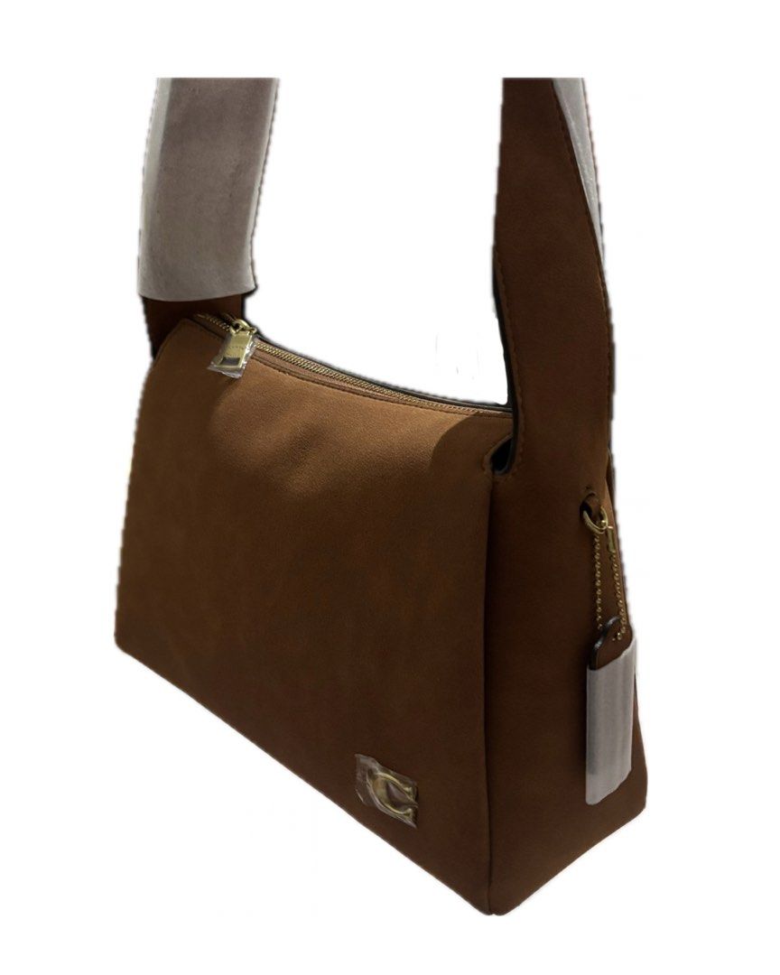 Coach Brown Suede Shoulder Bag (Category: Luxury Bags & Wallets) located in Manaoag. Submitted by ianka10 (Listing ID 1467306981, Image 1). Description: NEW ARRIVAL!! (Sourced from JPN and KOR) - Elegant gold-tone hardware and secure top zip closure - Features classic interior leather storypatch with embossed lettering and snap closure - Coach hangtag on the side - Perfect for daily use or special occasions - Send a message for inquiries or fast 