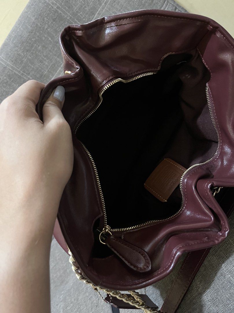 Coach Evelyn bag from Hawaii (Category: Luxury Bags & Wallets) located in Manila. Submitted by annearche (Listing ID 1467316472, Image 3). Description: - Coach shoulder bag - Rich deep burgundy quilted leather - Elegant gold-tone chain straps and hardware - Open main compartment with a secure middle zipper pocket - Clean interior lining with the signature leather Coach creed patch - Includes matching leather hangtag - Structured base helps the ba