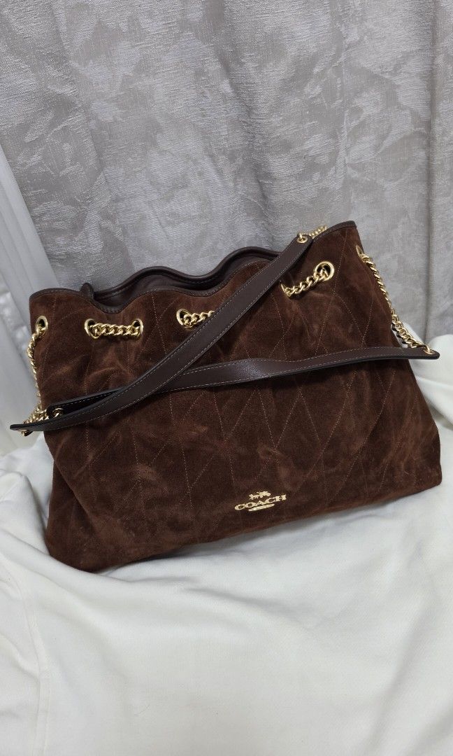 Authentic Coach Evelyn Bag in Suede (Category: Shoulder Bags) located in Santo Tomas. Submitted by cheskieeeeeeeee (Listing ID 1467291141, Image 1). Description: Coach Evelyn Shoulder Bag with Quilting in vintage brown suede, featuring signature gold-tone chain-link straps and diamond quilting. Got this in Canada and very hard to look for. Last priced posted ❤️.