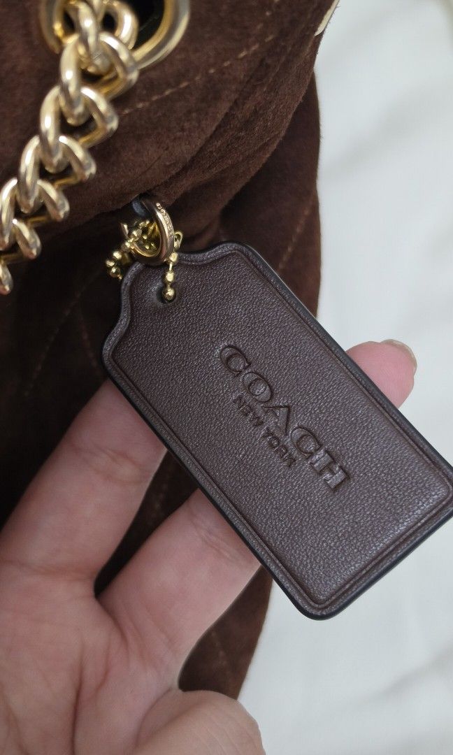 Authentic Coach Evelyn Bag in Suede (Category: Shoulder Bags) located in Santo Tomas. Submitted by cheskieeeeeeeee (Listing ID 1467291141, Image 2). Description: Coach Evelyn Shoulder Bag with Quilting in vintage brown suede, featuring signature gold-tone chain-link straps and diamond quilting. Got this in Canada and very hard to look for. Last priced posted ❤️.
