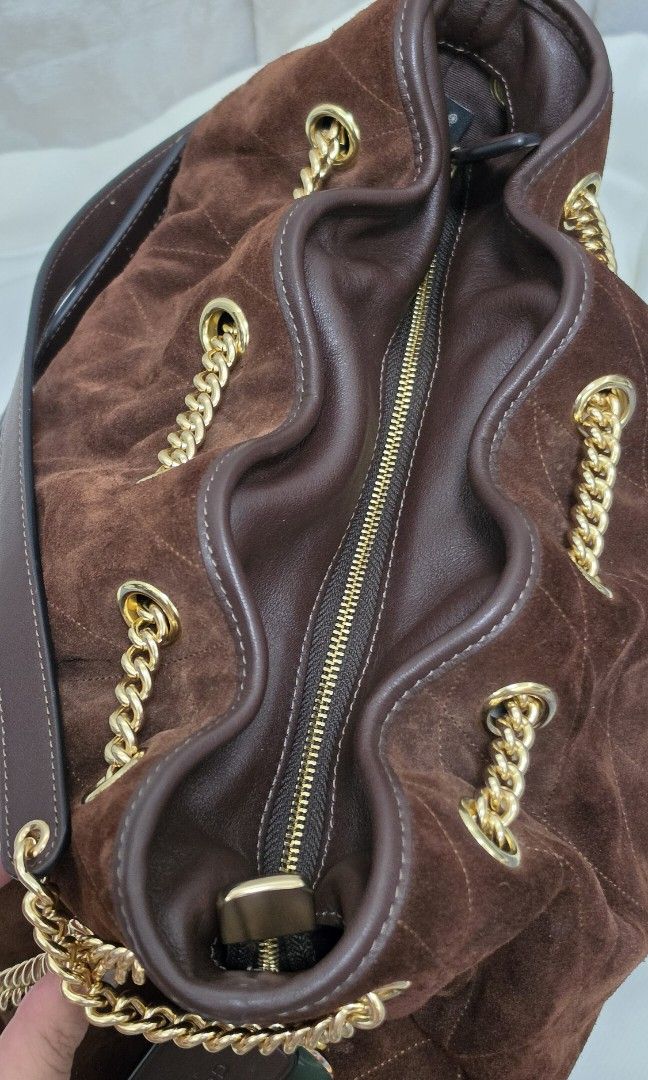 Authentic Coach Evelyn Bag in Suede (Category: Shoulder Bags) located in Santo Tomas. Submitted by cheskieeeeeeeee (Listing ID 1467291141, Image 3). Description: Coach Evelyn Shoulder Bag with Quilting in vintage brown suede, featuring signature gold-tone chain-link straps and diamond quilting. Got this in Canada and very hard to look for. Last priced posted ❤️.
