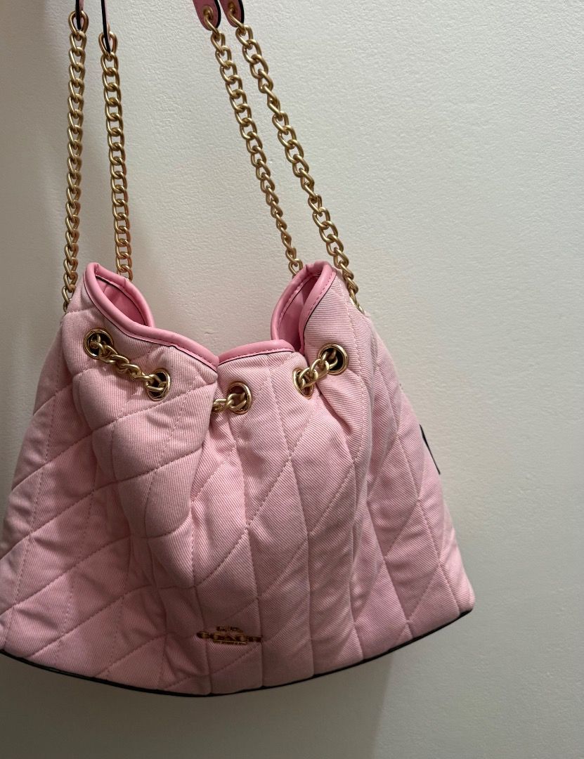 Coach Evelyn Denim Pink (Category: Luxury Bags & Wallets) located in Valenzuela. Submitted by raquesells (Listing ID 1467339422, Image 1). Description: - Brand: Coach - Style: Quilted shoulder bag with drawstring closure - Color: Soft pink with luxurious gold-tone hardware and chain straps - Interior: Pink lining featuring the classic leather Coach creed patch - Capacity: Comfortably fits your daily essentials - Condition: Good pre-loved conditio