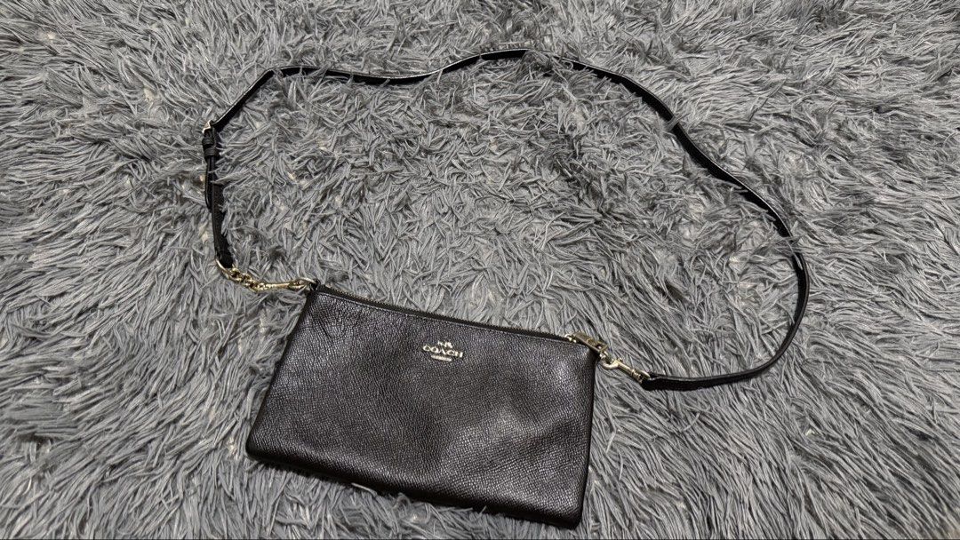 Coach Leather Crossbody Bag Black (Category: Cross-body Bags) located in San Pedro. Submitted by _eyamarie (Listing ID 1467211478, Image 1). Description: Coach black pebbled leather crossbody bag. Gold-tone hardware and Coach New York logo on front. Exterior slip pocket on the back. Zipper closure on top with fabric lining and card slots inside. Adjustable and removable strap with chain detail. Style number 52385, made in Vietnam..