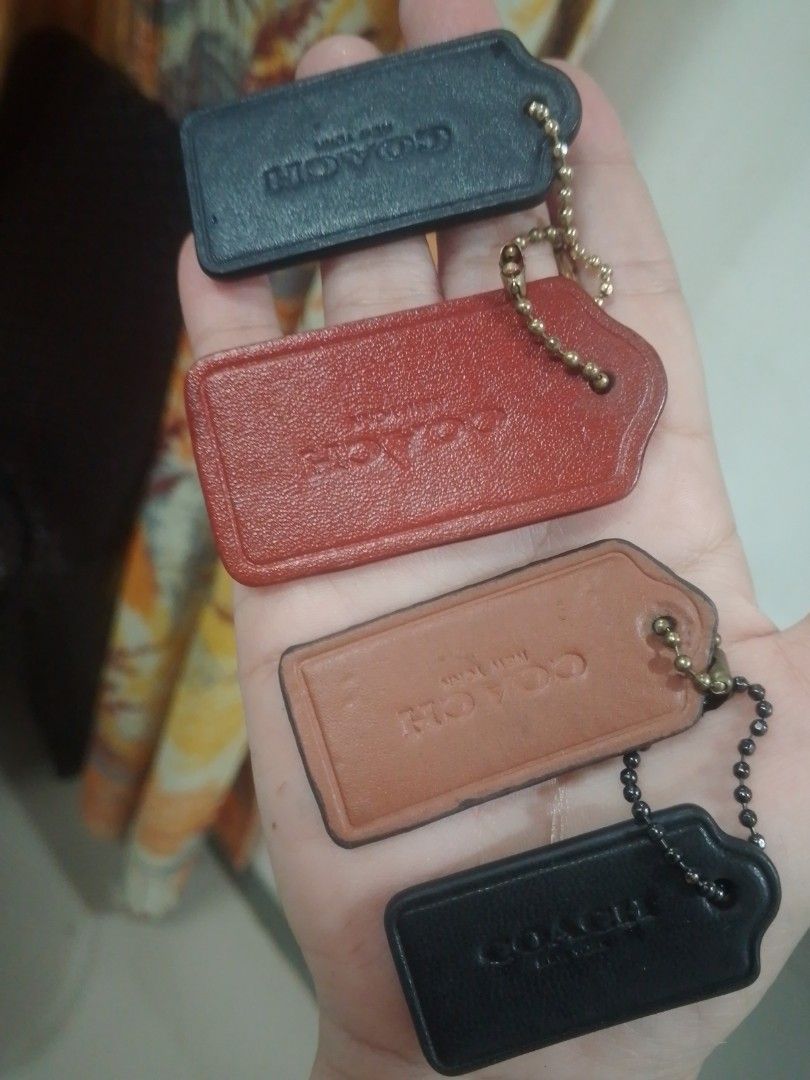 Coach Leather Hangtags Set Bag Charms (Category: Charms) located in Manila. Submitted by annemil_1984 (Listing ID 1466707065, Image 3). Description: - 100% Authentic Coach leather hangtags with ball chain straps - Includes dark grey embossed logo tag - Features dual-sided beige (with metal horse and carriage hardware) and vibrant blue tag - Dark gunmetal hardware throughout - Excellent, clean condition with no scuffs or cracks - Versatile accesso