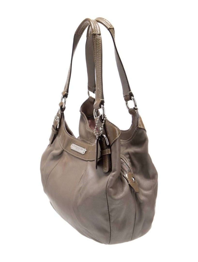 Coach vintage Leather Hobo Shoulder Bag (Category: Luxury Bags & Wallets) located in Manila. Submitted by lovelypreloved1497 (Listing ID 1467282497, Image 3). Description: - Brand: Coach - Style: Hobo Shoulder Bag - Hardware: Silver-tone with front metal logo plaque - Straps: Double straps with buckle details - Pockets: Convenient side zipper pocket - Interior: Roomy with fabric lining - Extras: Includes hanging leather hangtag - with minimal siz