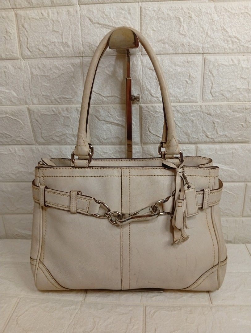 Coach Leather Tote Handbag Off-White (Category: Shoulder Bags) located in Las Pinas. Submitted by etoksi1234 (Listing ID 1467238853, Image 1). Description: Pre-loved Coach leather tote bag featuring silver hardware, double top handles, and spacious interior compartments. Shows visible signs of use including handle wear, surface scuffs, and stains on the body and corners..
