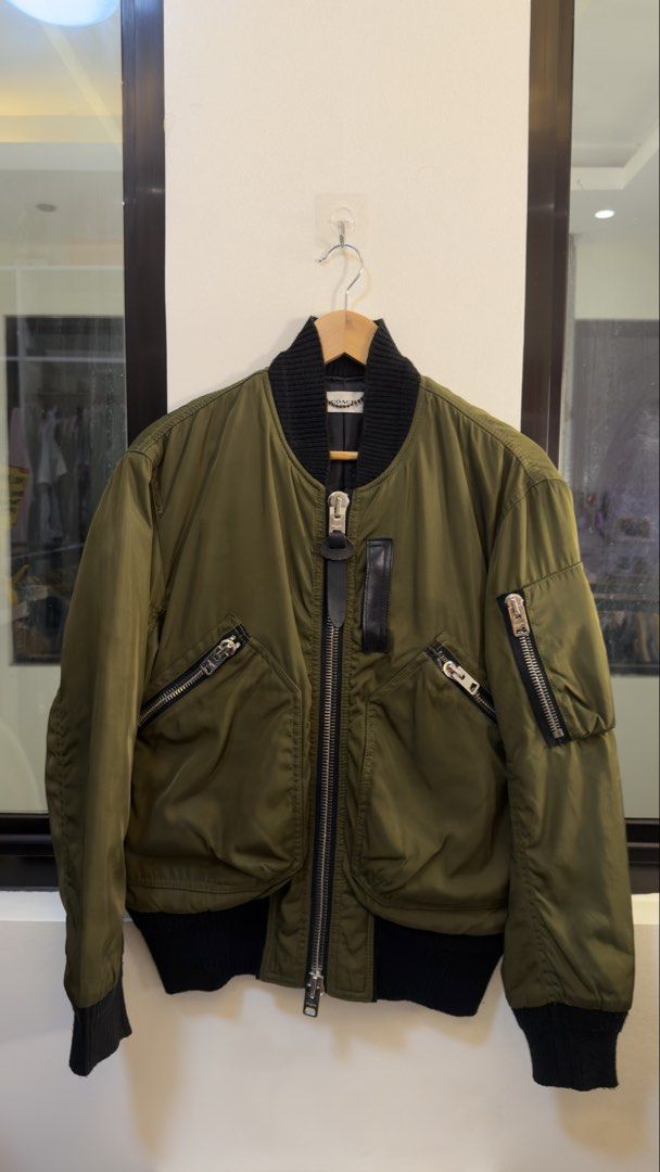 Coach Olive Green Nylon Bomber Jacket Size L (Category: Coats, Jackets and Outerwear) located in Paranaque City. Submitted by mykapoynton (Listing ID 1467240576, Image 2). Description: Coach Olive Green Nylon Bomber Jacket Size L - Color: Olive green with black ribbed collar, cuffs, and hem - Material: Nylon shell with cow leather trim; polyester and cupro blend lining - Features: Front zip with leather pull, slanted chest zipper pockets, and lef