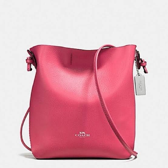 Coach Pink Leather Crossbody Bag (Category: Luxury Bags & Wallets) located in Iloilo. Submitted by amandamiamae (Listing ID 1467280482, Image 1). Description: - Brand: Coach - Material: Pebbled leather in bright pink - Hardware: Silver-tone with subtle front logo stamp - Strap: Adjustable crossbody strap with matching hangtag charm - Interior: Spacious compartment for daily essentials - Style: Vibrant and casual, great for everyday wear.