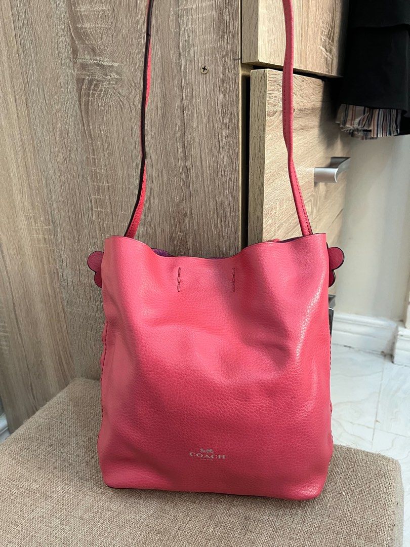 Coach Pink Leather Crossbody Bag (Category: Luxury Bags & Wallets) located in Iloilo. Submitted by amandamiamae (Listing ID 1467280482, Image 2). Description: - Brand: Coach - Material: Pebbled leather in bright pink - Hardware: Silver-tone with subtle front logo stamp - Strap: Adjustable crossbody strap with matching hangtag charm - Interior: Spacious compartment for daily essentials - Style: Vibrant and casual, great for everyday wear.