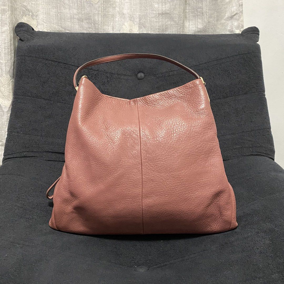 Coach Pink Leather Shoulder Bag (Category: Luxury Bags & Wallets) located in Baliuag. Submitted by thriftpuff (Listing ID 1467320727, Image 2). Description: - Authentic Coach shoulder bag in gorgeous pink pebbled leather - Elegant gold-tone hardware and gold foil Coach logo stamp - Dual shoulder straps with stylish rectangular connectors - Organized interior with divided compartments and a central zipped section - Additional interior slip pockets