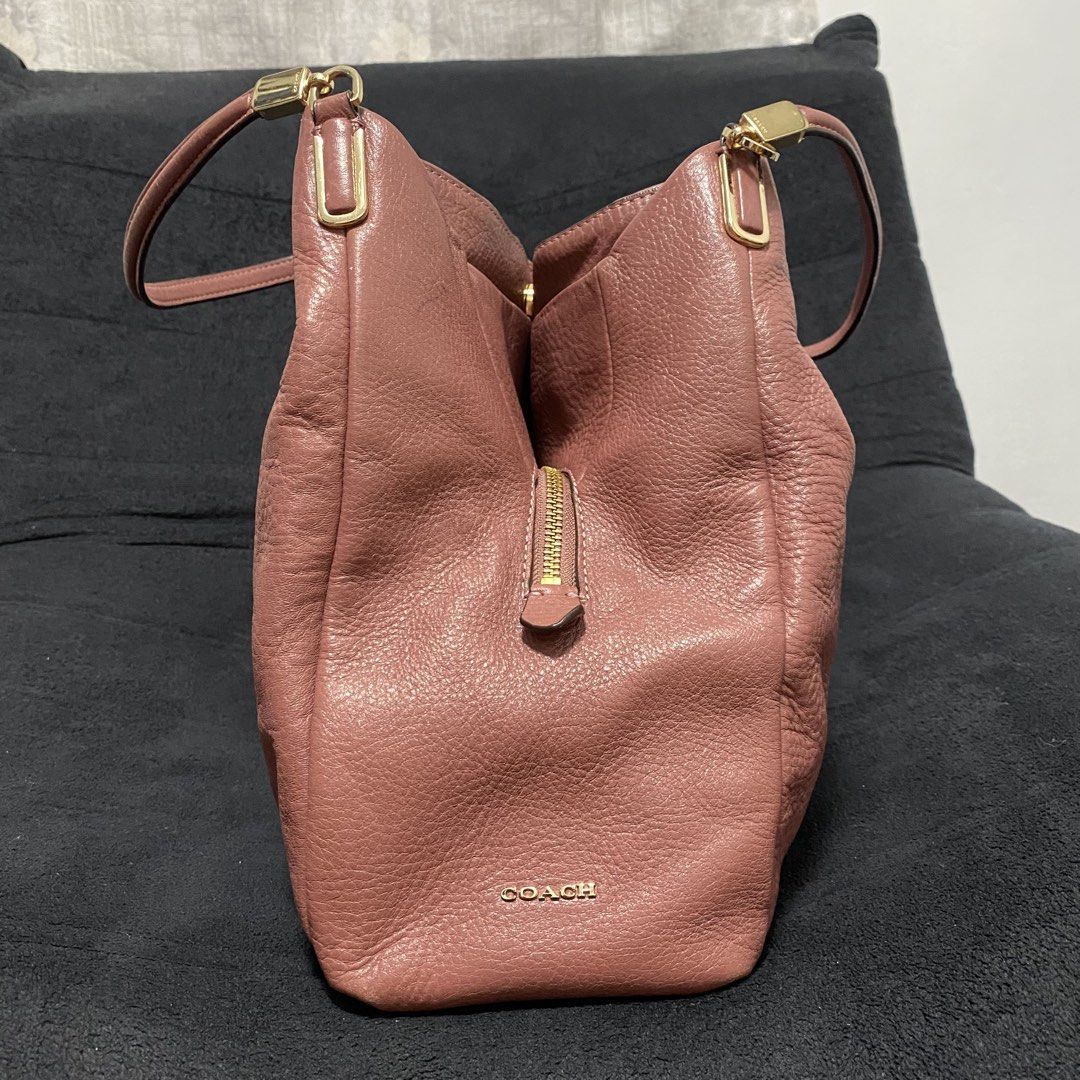 Coach Pink Leather Shoulder Bag (Category: Luxury Bags & Wallets) located in Baliuag. Submitted by thriftpuff (Listing ID 1467320727, Image 3). Description: - Authentic Coach shoulder bag in gorgeous pink pebbled leather - Elegant gold-tone hardware and gold foil Coach logo stamp - Dual shoulder straps with stylish rectangular connectors - Organized interior with divided compartments and a central zipped section - Additional interior slip pockets