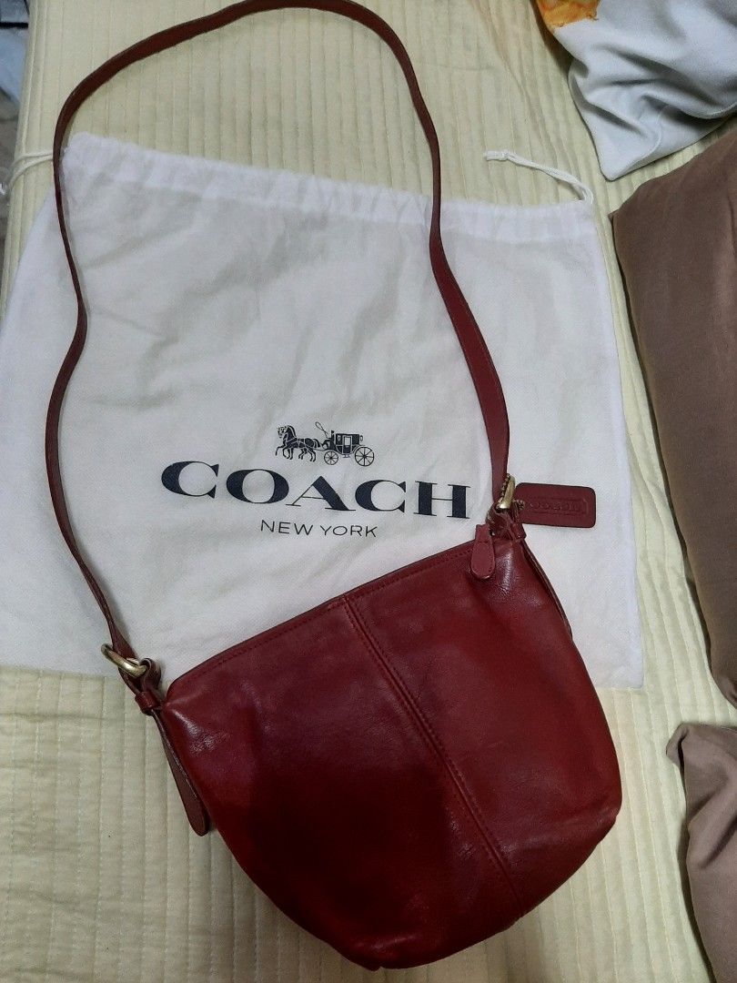 Coach Red Leather Shoulder Bag with Dust Bag (Category: Luxury Bags & Wallets) located in Bulacan. Submitted by edisoncert71953 (Listing ID 1467254993, Image 2). Description: - Authentic Coach red leather shoulder bag - Includes original white Coach New York dust bag - Long adjustable strap with elegant gold-tone hardware - Secure top zip closure - Chic front seam detailing and hanging leather logo tag - Made of soft, premium deep red leather.