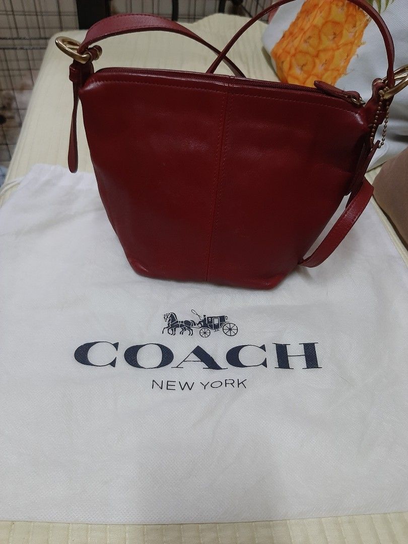 Coach Red Leather Shoulder Bag with Dust Bag (Category: Luxury Bags & Wallets) located in Bulacan. Submitted by edisoncert71953 (Listing ID 1467254993, Image 1). Description: - Authentic Coach red leather shoulder bag - Includes original white Coach New York dust bag - Long adjustable strap with elegant gold-tone hardware - Secure top zip closure - Chic front seam detailing and hanging leather logo tag - Made of soft, premium deep red leather.