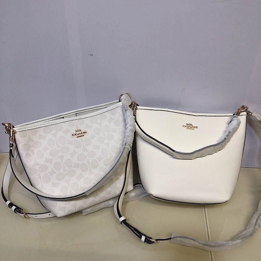 Coach White Bucket Bag Crossbody (Category: Cross-body Bags) located in Manila. Submitted by clairetot (Listing ID 1467203310, Image 1). Description: Coach bucket bag in solid white pebble leather or signature monogram canvas. Features gold hardware, a top handle, and a detachable long strap. Brand new with protective foam, secure closures, and a clean interior..