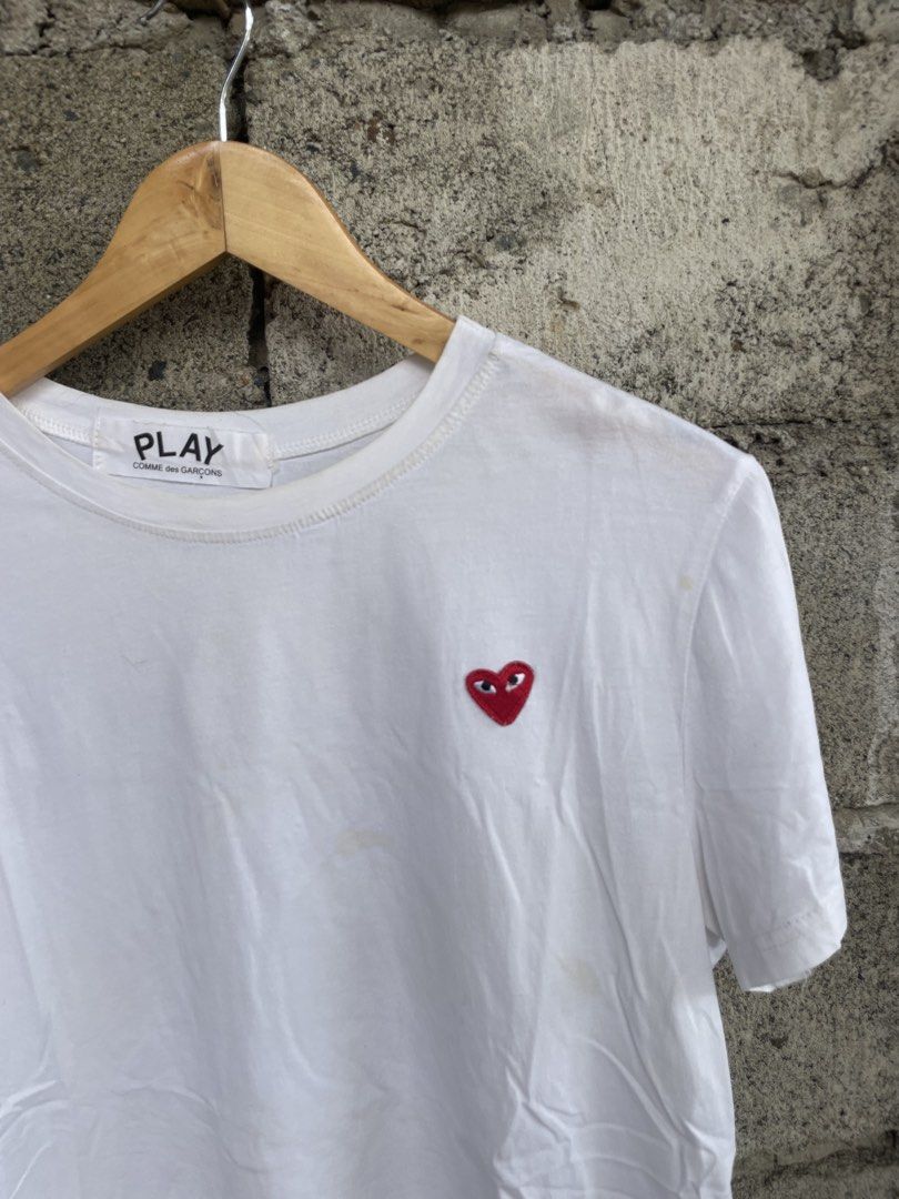 COMME des GARÇONS PLAY White Heart Tee (Category: Activewear) located in Dagupan City. Submitted by thriftykiddo.ph (Listing ID 1467226657, Image 3). Description: - Brand: COMME des GARÇONS PLAY - Color: Classic White - Design: Iconic embroidered red heart logo on chest - Fit: Standard fit, crew neck, short sleeves - Authenticity details: Interior collar tag and wash label near hem intact - Condition: Pre-owned, shows minor signs of wear and fain