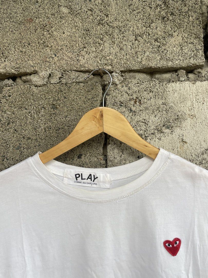 COMME des GARÇONS PLAY White Heart Tee (Category: Activewear) located in Dagupan City. Submitted by thriftykiddo.ph (Listing ID 1467226657, Image 2). Description: - Brand: COMME des GARÇONS PLAY - Color: Classic White - Design: Iconic embroidered red heart logo on chest - Fit: Standard fit, crew neck, short sleeves - Authenticity details: Interior collar tag and wash label near hem intact - Condition: Pre-owned, shows minor signs of wear and fain