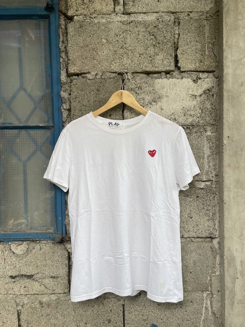 COMME des GARÇONS PLAY White Heart Tee (Category: Activewear) located in Dagupan City. Submitted by thriftykiddo.ph (Listing ID 1467226657, Image 1). Description: - Brand: COMME des GARÇONS PLAY - Color: Classic White - Design: Iconic embroidered red heart logo on chest - Fit: Standard fit, crew neck, short sleeves - Authenticity details: Interior collar tag and wash label near hem intact - Condition: Pre-owned, shows minor signs of wear and fain