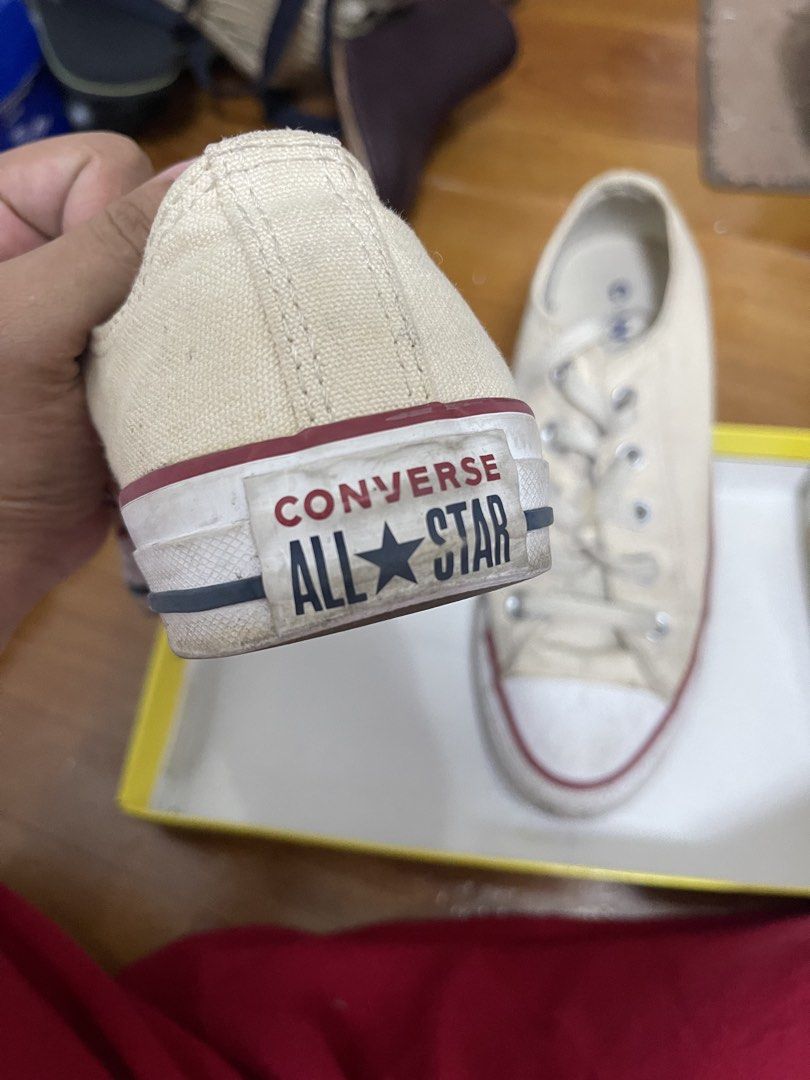 Converse All Star Low Top Off-White Sneakers (Category: Sneakers) located in Taguig. Submitted by 1307maloc (Listing ID 1467213794, Image 2). Description: - Brand: Converse All Star - Style: Low top sneakers - Color: Off-white canvas with red and blue midsole piping - Details: White rubber toe cap, silver metal eyelets, flat laces, and heel patch branding - Condition: Shows visible signs of previous wear on the canvas and toe caps.