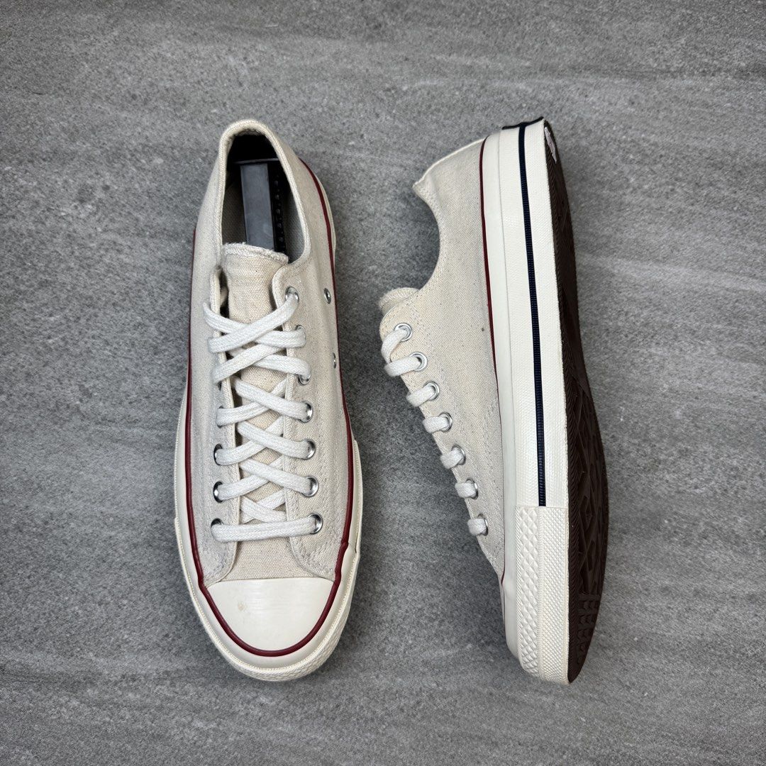 Converse Chuck 70 Low Parchment Canvas Sneakers (Category: Sneakers) located in Manolo Fortich. Submitted by thrift_by_biji (Listing ID 1467266380, Image 3). Description: - Brand: Converse Chuck 70 Low Top - Colorway: Parchment (Classic Off-White) - Details: Signature canvas upper, red and navy midsole piping, silver eyelets, white laces - Soles: Brown rubber with minimal wear on tread - Condition: Very clean, well-maintained, and ready to wear.