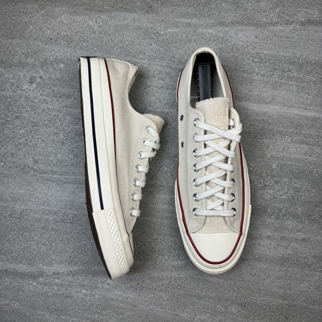 Converse Chuck 70 Low Parchment Canvas Sneakers (Category: Sneakers) located in Manolo Fortich. Submitted by thrift_by_biji (Listing ID 1467266380, Image 2). Description: - Brand: Converse Chuck 70 Low Top - Colorway: Parchment (Classic Off-White) - Details: Signature canvas upper, red and navy midsole piping, silver eyelets, white laces - Soles: Brown rubber with minimal wear on tread - Condition: Very clean, well-maintained, and ready to wear.