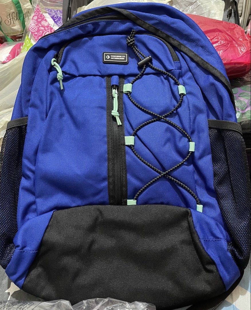 Converse Co. Accessories Blue and Black Backpack (Category: Backpacks) located in Quezon City. Submitted by stuffsrus (Listing ID 1467189240, Image 1). Description: Converse Co. Accessories backpack in bright blue and black. Large main compartment plus a front vertical zipped pocket with light green zipper pulls. Elastic bungee cord on the front panel for extra storage. Mesh side pockets on both sides for water bottles. Black top handle and padde