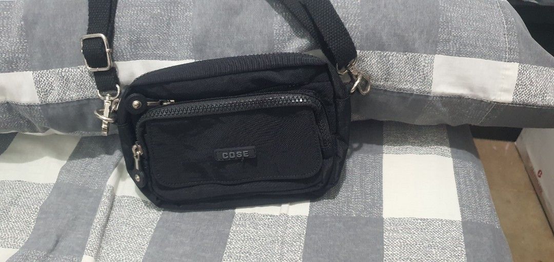 COSE Black Nylon Crossbody Bag with Multiple Zip Pockets (Category: Cross-body Bags) located in Paranaque City. Submitted by personal_preloved40 (Listing ID 1467259989, Image 1). Description: - Brand: COSE - Material: Durable black nylon with grey interior lining - Design: Compact crossbody with multiple interior and exterior zippered compartments - Hardware: Silver-tone hardware with sturdy strap clips - Strap: Adjustable black shoulder/crossbod