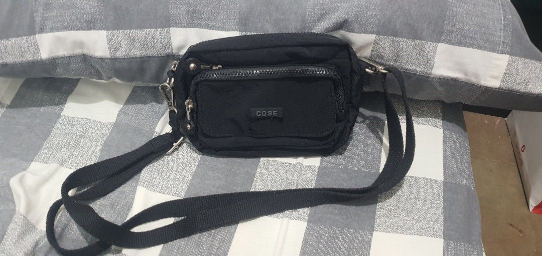 COSE Black Nylon Crossbody Bag with Multiple Zip Pockets (Category: Cross-body Bags) located in Paranaque City. Submitted by personal_preloved40 (Listing ID 1467259989, Image 2). Description: - Brand: COSE - Material: Durable black nylon with grey interior lining - Design: Compact crossbody with multiple interior and exterior zippered compartments - Hardware: Silver-tone hardware with sturdy strap clips - Strap: Adjustable black shoulder/crossbod