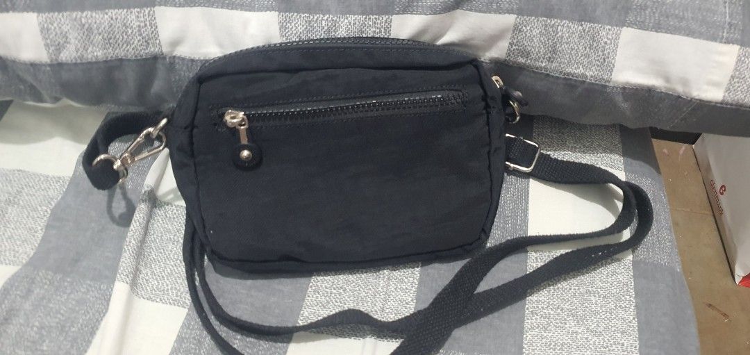COSE Black Nylon Crossbody Bag with Multiple Zip Pockets (Category: Cross-body Bags) located in Paranaque City. Submitted by personal_preloved40 (Listing ID 1467259989, Image 3). Description: - Brand: COSE - Material: Durable black nylon with grey interior lining - Design: Compact crossbody with multiple interior and exterior zippered compartments - Hardware: Silver-tone hardware with sturdy strap clips - Strap: Adjustable black shoulder/crossbod