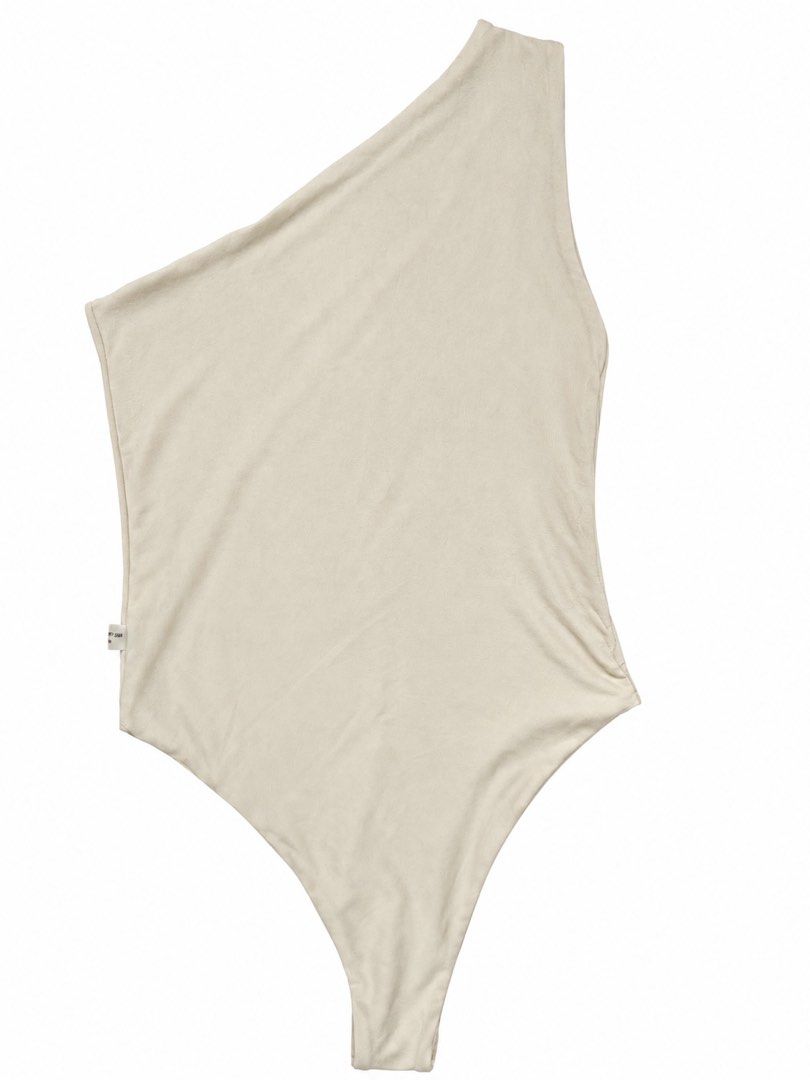 Cream One-Shoulder Bodysuit (Category: Sleeveless) located in Manila. Submitted by karely (Listing ID 1467241961, Image 1). Description: - Colour: Cream - Style: One-shoulder minimalist bodysuit with high-cut legs - Fabric: Smooth and soft texture - Condition: Small side tag intact - Versatility: Perfect basic for layering or wearing on its own with denim or skirts.