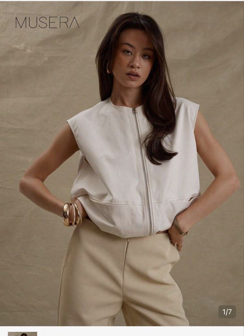 Cream Sleeveless Zip-Up Vest with Pockets (Category: Sleeveless) located in Makati City. Submitted by camdeclutters (Listing ID 1467298619, Image 2). Description: - Color: Neutral cream - Material: Lightweight and comfortable - Design: Full front zipper, round neckline, and sleeveless style - Features: Two front pockets and gathered hem for a subtle puffed shape - Styling: Easy to layer over tops and shirts - Condition: Clean and ready to wear.