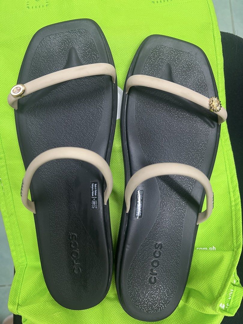 Crocs Sandals Black Women Size 9 (Category: Sandals) located in Quezon City. Submitted by aricango (Listing ID 1467360793, Image 2). Description: Wala pa to sa Philippines!! 🇵🇭 - Brand: Crocs - Condition: almost new (worn once sa mall but big size talaga sya for me) - Size: Women's US 9 - Color: Black footbed with cream slim dual straps - Features: Square toe, textured footbed, decorative charms - Origin: Made in Vietnam RFS: wrong size.