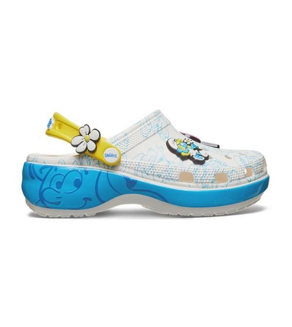 Crocs Smurfs Platform Clog White (Category: Slippers and slides) located in Manila. Submitted by lovelypreloved1497 (Listing ID 1467281153, Image 2). Description: - Brand new with original product tag still attached bought in Canada - Authentic Smurfs x Crocs platform clogs in a white base with vibrant blue character graphics - Thick blue midsole platform for extra height and comfort - Yellow heel strap featuring a cute flower Jibbitz charm - Inc