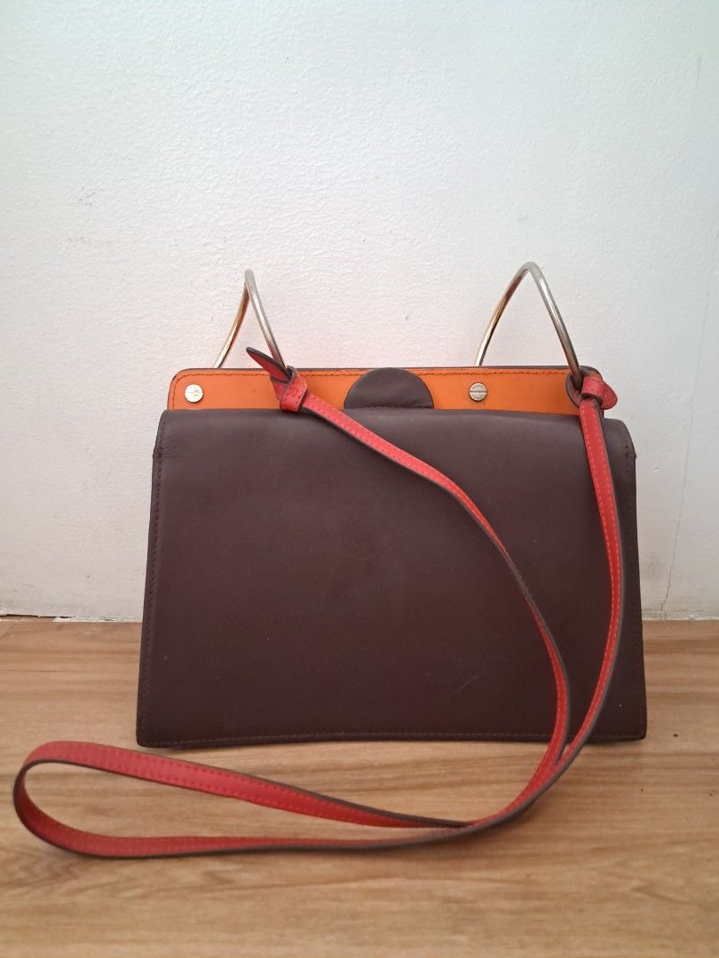 Danse Lente (Category: Cross-body Bags) located in Muntinlupa City. Submitted by msshoppingera (Listing ID 1467193476, Image 2). Description: Danse Lente leather bag in brown and orange colour. No scuffings, no stickiness, no foul smell. Payment first before shipping. Shipping fees will be shouldered by the buyer. No return No exchange. .