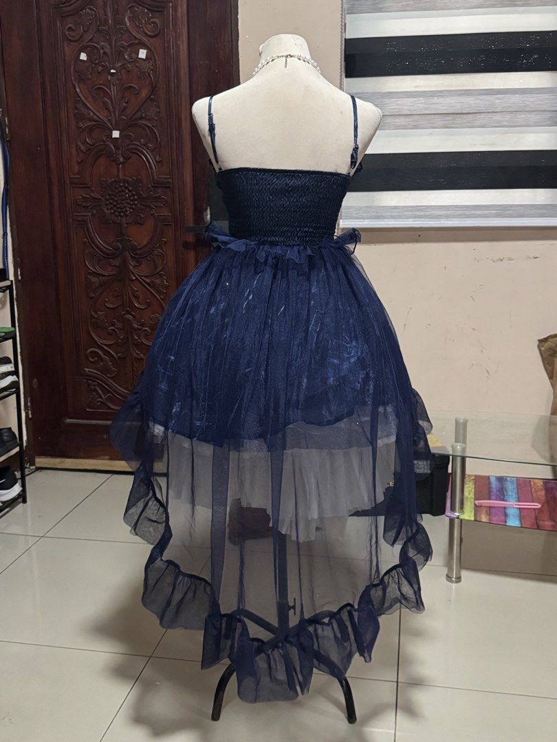 Dark Blue High-Low Ruffle Spaghetti Strap Dress (Category: Dresses) located in Manila. Submitted by athanaxia (Listing ID 1467312316, Image 2). Description: - Color: Navy blue - Design: Spaghetti straps, gathered bust, and black waist ribbon - Skirt: Voluminous high-low sheer dark tulle with a white ruffled underskirt - Fit: Smocked back panel for comfortable stretch - Style: Great for parties or alternative fashion looks.