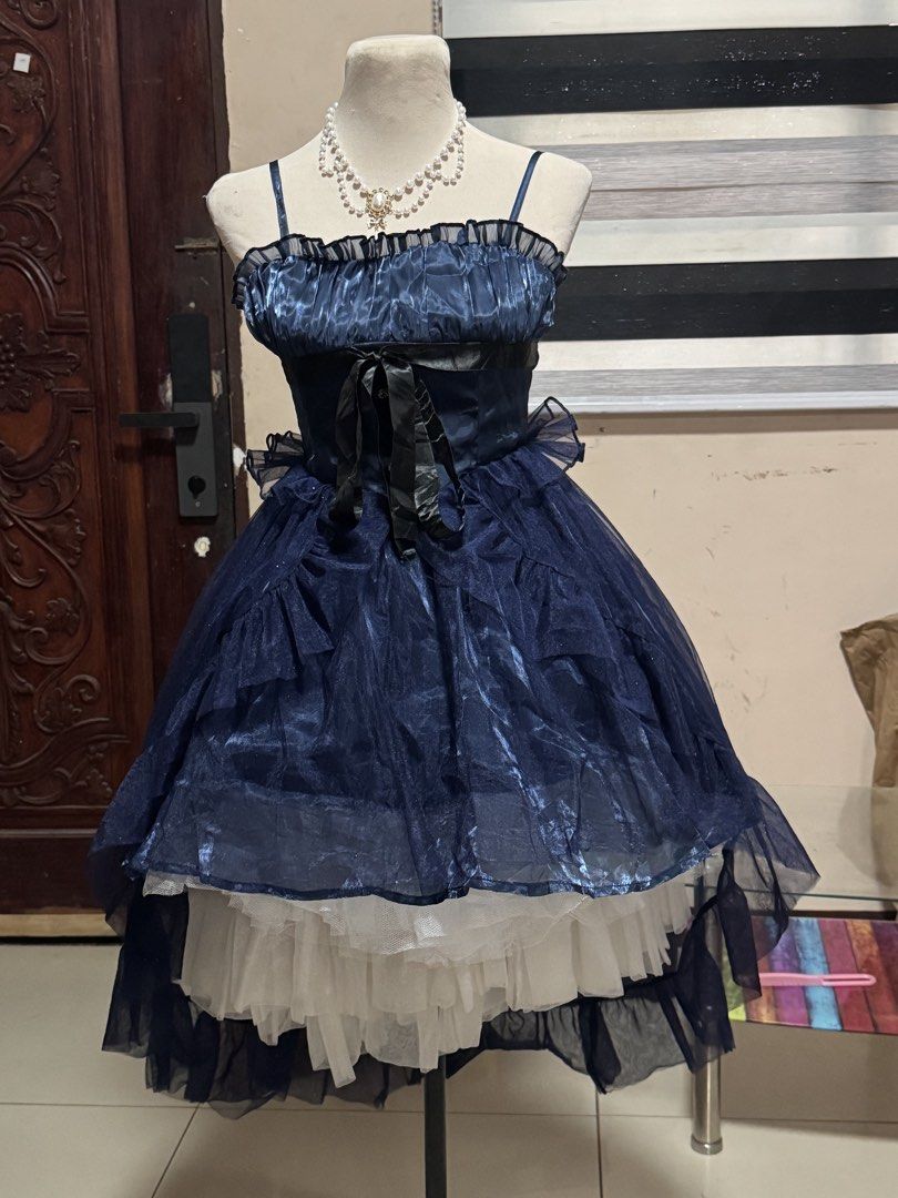 Dark Blue High-Low Ruffle Spaghetti Strap Dress (Category: Dresses) located in Manila. Submitted by athanaxia (Listing ID 1467312316, Image 1). Description: - Color: Navy blue - Design: Spaghetti straps, gathered bust, and black waist ribbon - Skirt: Voluminous high-low sheer dark tulle with a white ruffled underskirt - Fit: Smocked back panel for comfortable stretch - Style: Great for parties or alternative fashion looks.