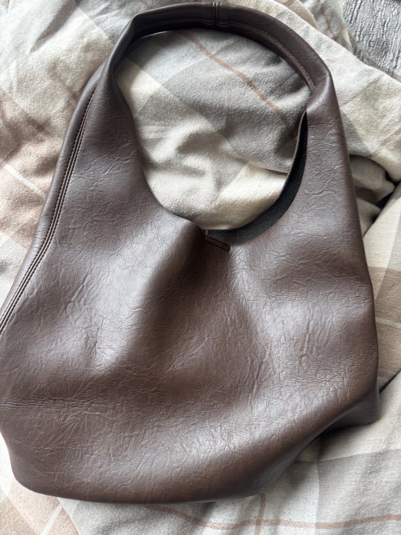 Dark Brown Leather Hobo Shoulder Bag (Category: Shoulder Bags) located in Mandaluyong City. Submitted by nicxannc (Listing ID 1467241163, Image 1). Description: - Color: Rich dark brown - Material: Supple faux leather - Style: Slouchy hobo shape with a clean, seamless front - Comfort: Built-in strap designed for comfortable shoulder wear - Capacity: Deep interior cavity easily holds all your daily essentials - Purpose: Perfect everyday carryall.
