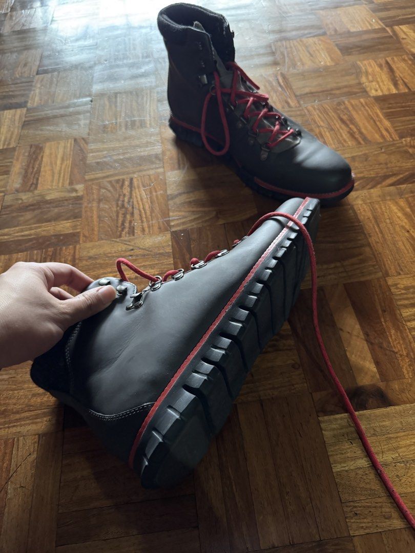 Dark grey leather hiking boots with red laces (Category: Boots) located in Manila. Submitted by seangoart (Listing ID 1467174696, Image 1). Description: - Color: Dark grey leather with vibrant red laces - Hardware: Durable metal eyelets and speed hooks - Comfort: Padded ankle collar for extra support - Sole: Thick lugged soles with a stylish red accent stripe - Condition: Clean uppers with minimal creasing.