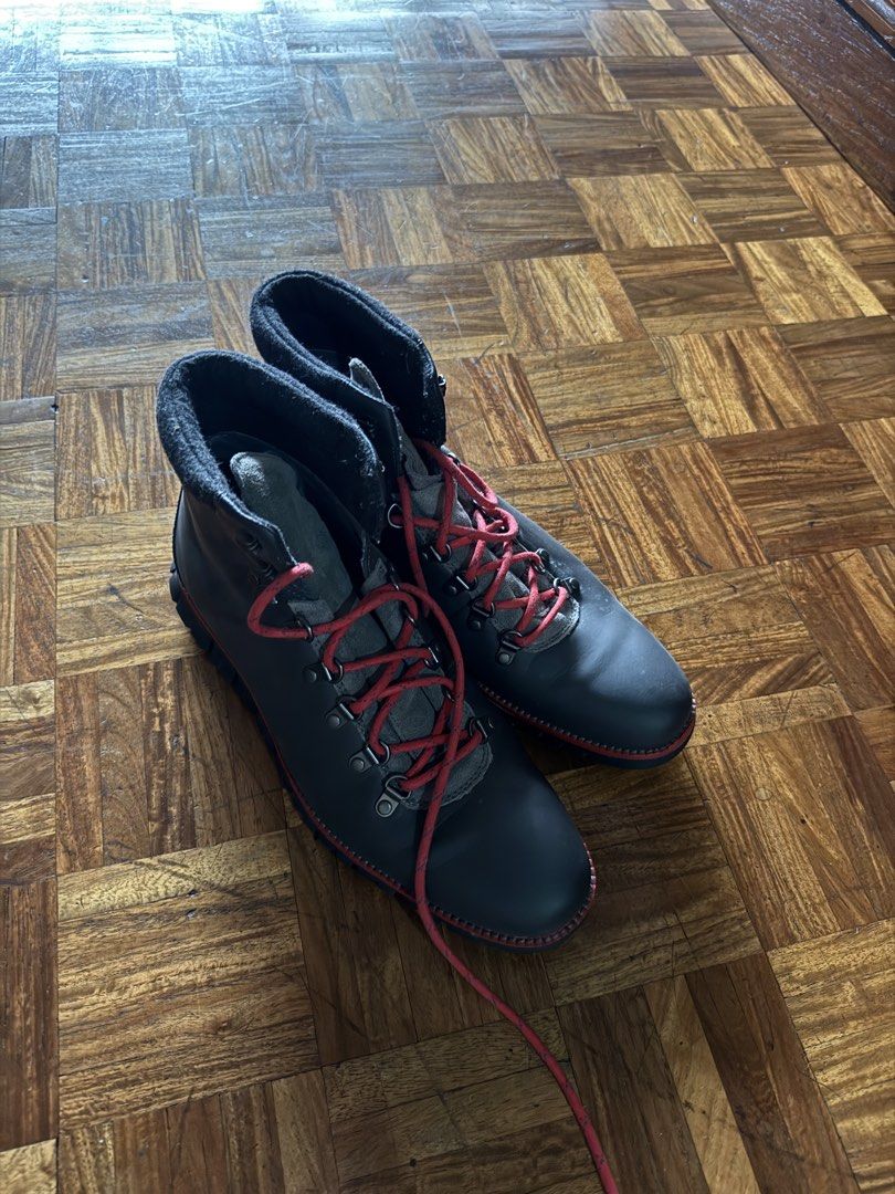Dark grey leather hiking boots with red laces (Category: Boots) located in Manila. Submitted by seangoart (Listing ID 1467174696, Image 3). Description: - Color: Dark grey leather with vibrant red laces - Hardware: Durable metal eyelets and speed hooks - Comfort: Padded ankle collar for extra support - Sole: Thick lugged soles with a stylish red accent stripe - Condition: Clean uppers with minimal creasing.
