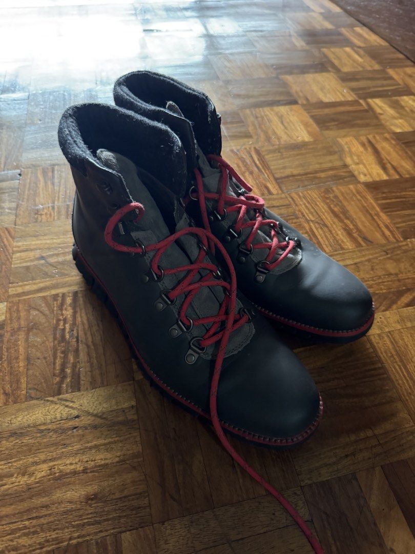 Dark grey leather hiking boots with red laces (Category: Boots) located in Manila. Submitted by seangoart (Listing ID 1467174696, Image 2). Description: - Color: Dark grey leather with vibrant red laces - Hardware: Durable metal eyelets and speed hooks - Comfort: Padded ankle collar for extra support - Sole: Thick lugged soles with a stylish red accent stripe - Condition: Clean uppers with minimal creasing.