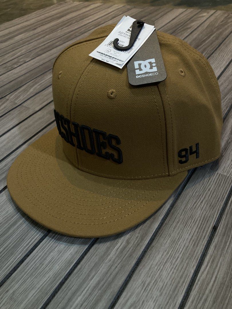 DC Shoes ADYHA04170 Semi Pro Snapback Cap Tan (Category: Caps & Hats) located in Trece Martires City. Submitted by thriftkoto.91 (Listing ID 1467268455, Image 2). Description: - Brand: DC Shoes - Style: Semi-pro snapback cap - Color: Tan / Brown twill - Details: Black embroidered 'DC SHOES' front lettering and '94' side number - Fit: Adjustable plastic snapback closure - Interior: Branded taping and comfortable sweatband - Condition: Brand new wi