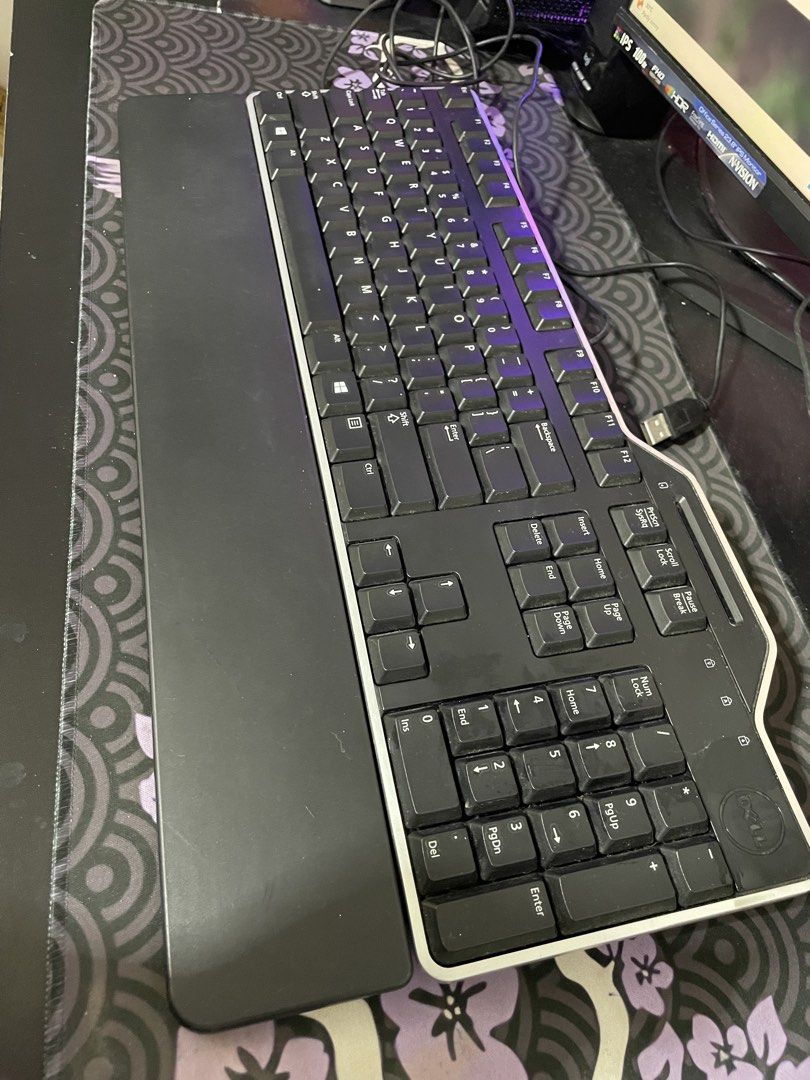 Dell wired ergonomic computer keyboard with palm rest (Category: Computer Keyboard) located in General Trias. Submitted by ashi_kt0 (Listing ID 1467210366, Image 2). Description: - Brand: Dell - Type: Wired keyboard with standard USB connection - Design: Full-size layout including a dedicated numeric keypad and function row - Comfort: Built-in black palm rest for ergonomic wrist support during long typing sessions - Condition: Solid build, clean,