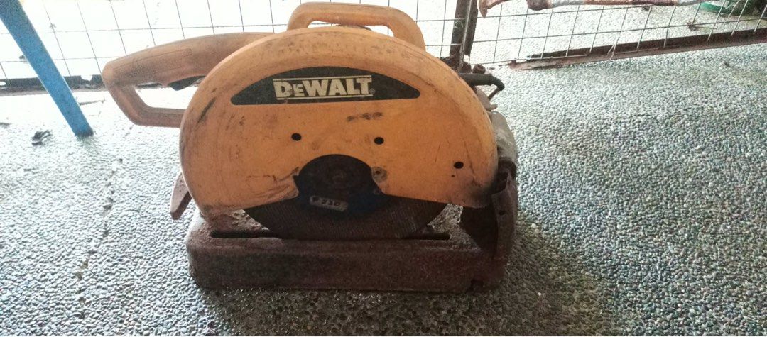 Dewalt Chopsaw (Category: Construction Tools & Equipment) located in Manila. Submitted by rawpellicule (Listing ID 1467356306, Image 1). Description: - Brand: Dewalt - Model: D28710 (Serial No. 008569) - Type: 14-inch Heavy-Duty Chop Saw / Metal Cutter - Power: 2200W, 220-240V - Motor Speed: 3800 RPM - Origin: Made in PRC - Condition: Fully working condition. Shows workshop dust, dirt buildup, and rust on the heavy metal base from use. Needs clea