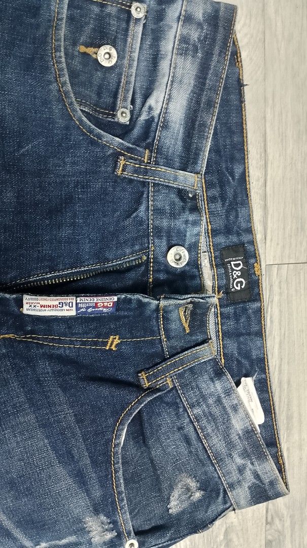 D&G Distressed Blue Jeans (Category: Jeans) located in Pasig City. Submitted by lonski1181 (Listing ID 1467271027, Image 3). Description: D&G blue denim jeans with heavy wash and distressing details. Classic five-pocket setup, button fly. Star embroidery design on back pockets. Leather patch on the back waistband. Straight leg cut. Faded wash patterns throughout front and back. Sturdy material, great daily wear denim. authentic D&G jeans fits 28-