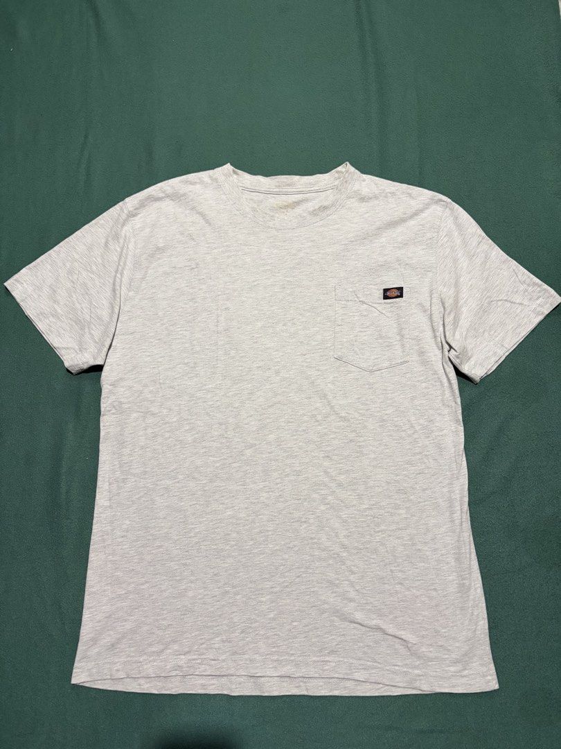 Dickies Grey Pocket T-Shirt (Category: Tshirts & Polo Shirts ) located in Guihulngan. Submitted by fbthriftgoodsniace (Listing ID 1467318679, Image 1). Description: - Brand: Dickies - Color: Heather Grey - Features: Single chest pocket with woven brand logo tag - Condition: Clean, ready to wear (collar tag is worn out) - Size/Measurements: Pit to pit ~23 inches, Total length ~32 inches.