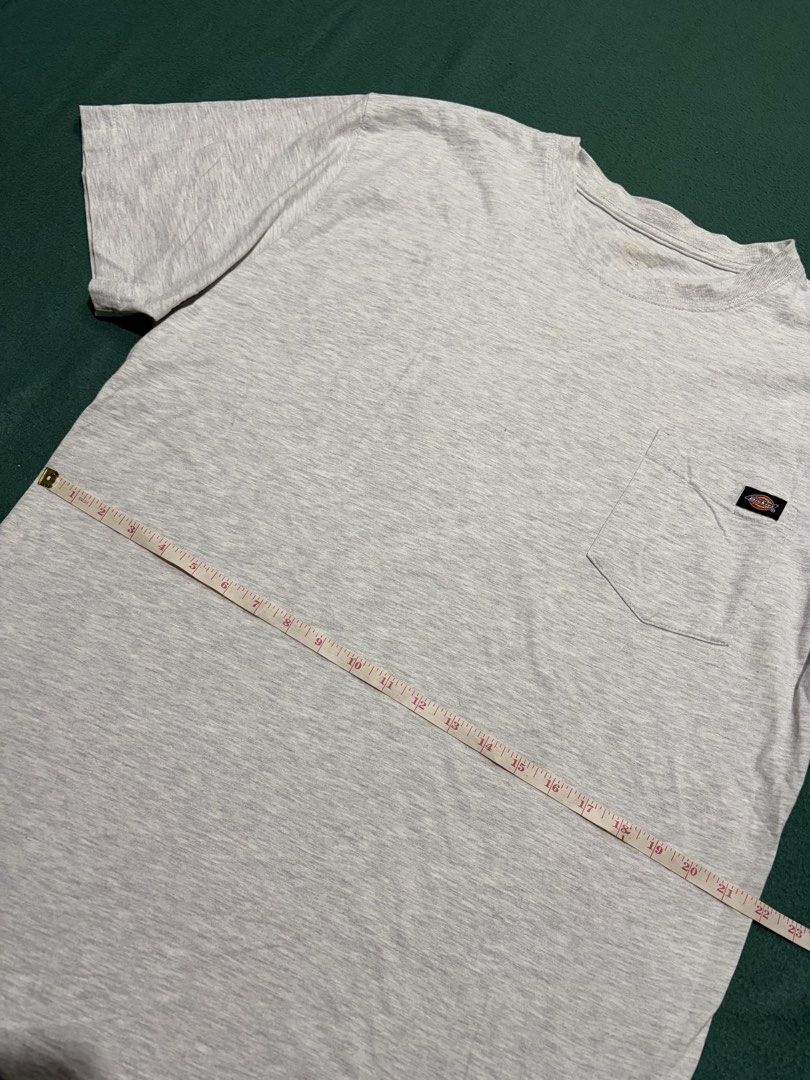 Dickies Grey Pocket T-Shirt (Category: Tshirts & Polo Shirts ) located in Guihulngan. Submitted by fbthriftgoodsniace (Listing ID 1467318679, Image 3). Description: - Brand: Dickies - Color: Heather Grey - Features: Single chest pocket with woven brand logo tag - Condition: Clean, ready to wear (collar tag is worn out) - Size/Measurements: Pit to pit ~23 inches, Total length ~32 inches.