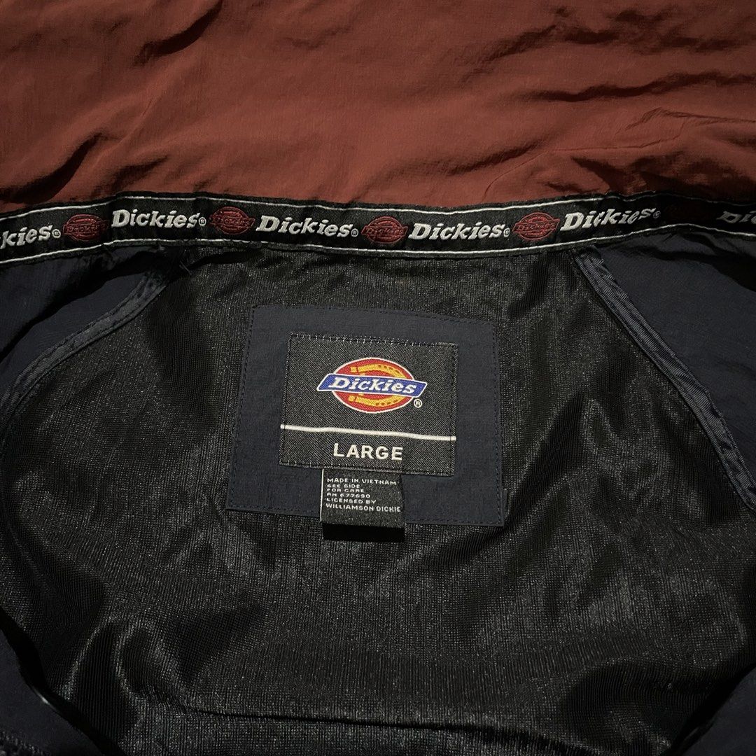Dickies Navy Windbreaker Jacket Size Large (Category: Coats, Jackets and Outerwear) located in Porac. Submitted by good.thriftsph (Listing ID 1467191408, Image 2). Description: - Brand: Dickies - Item: Hooded Windbreaker Jacket - Color: Navy blue with maroon inner collar and olive green hood trim - Size: Large (100) - Material: Durable nylon and polyester shell with black inner lining - Details: Black rubberized Dickies logo patch on left chest, 