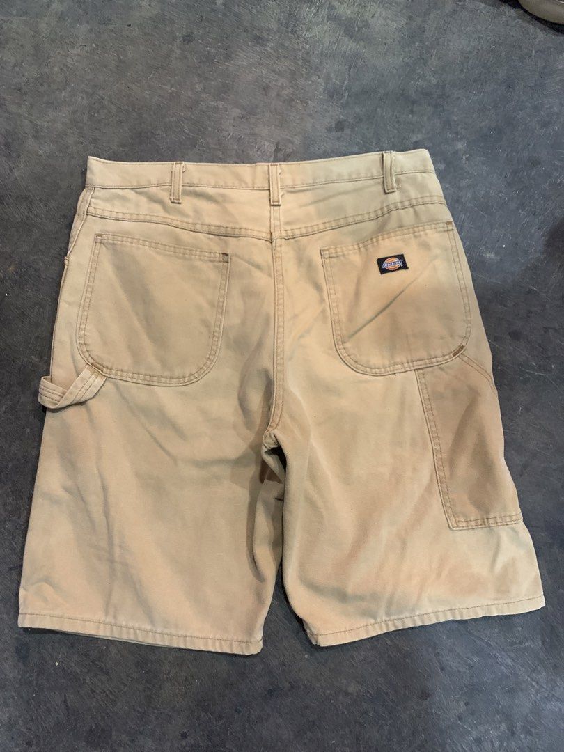 Dickies Tan Canvas Carpenter Shorts (Category: Shorts) located in Cagayan de Oro. Submitted by agboysalis60090 (Listing ID 1467338605, Image 2). Description: Dickies canvas carpenter shorts in a classic tan color. Durable cotton duck fabric with utility pockets on the side and a hammer loop. Sturdy metal button fly and YKK brass zipper. Casual streetwear fit, great everyday workwear style. Shows some minor wear and faint marks on the front..