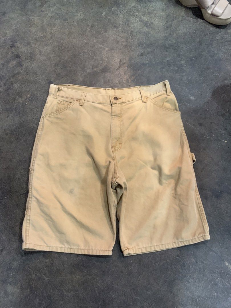 Dickies Tan Canvas Carpenter Shorts (Category: Shorts) located in Cagayan de Oro. Submitted by agboysalis60090 (Listing ID 1467338605, Image 1). Description: Dickies canvas carpenter shorts in a classic tan color. Durable cotton duck fabric with utility pockets on the side and a hammer loop. Sturdy metal button fly and YKK brass zipper. Casual streetwear fit, great everyday workwear style. Shows some minor wear and faint marks on the front..