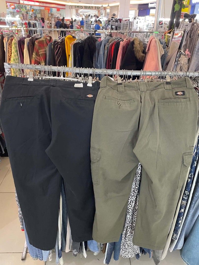 Dickies Work Pants and Cargo Pants Bundle (Category: Jeans) located in Cainta. Submitted by mariss.luxx (Listing ID 1467258773, Image 2). Description: - Brand: Dickies - Bundle includes: 2 pairs of pants (Solid black straight-leg work pants & Olive green cargo pants with side pockets) - Material: Sturdy, durable fabric construction - Style: Versatile staple pieces, perfect for everyday streetwear - Condition: Excellent.